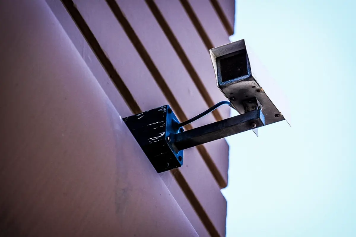 An ageing CCTV camera mounted on a building exterior